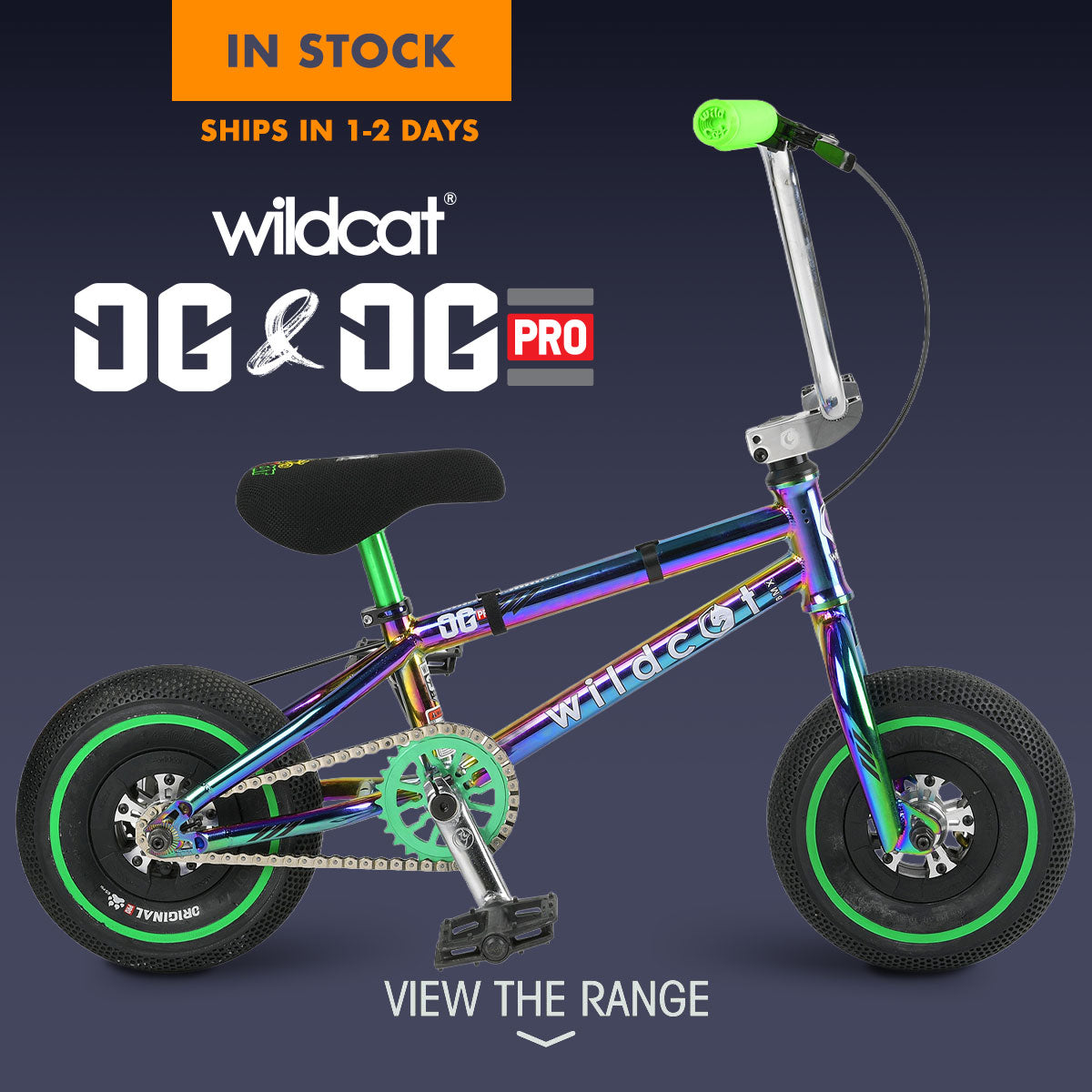 A small Wildcat OG & OG-Pro mini bmx with an oil-slick chrome frame, black seat and tires, and bright green accents on the handlebar grip, chainring, and wheel rims, shown on a dark blue gradient background.
